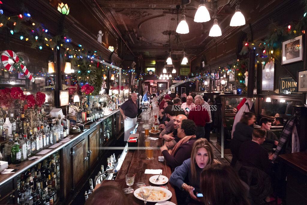Mark Lennihan FILE - In this Dec. 27, 2019, file photo, customers mingle in New York's Old Town Bar. With New York City at the epicenter of the coronavirus outbreak in the U.S. and its native-born among those offering crucial information to the nation in televised briefings, the New York accent has stepped up to the mic. (AP Photo/Mark Lennihan, File)