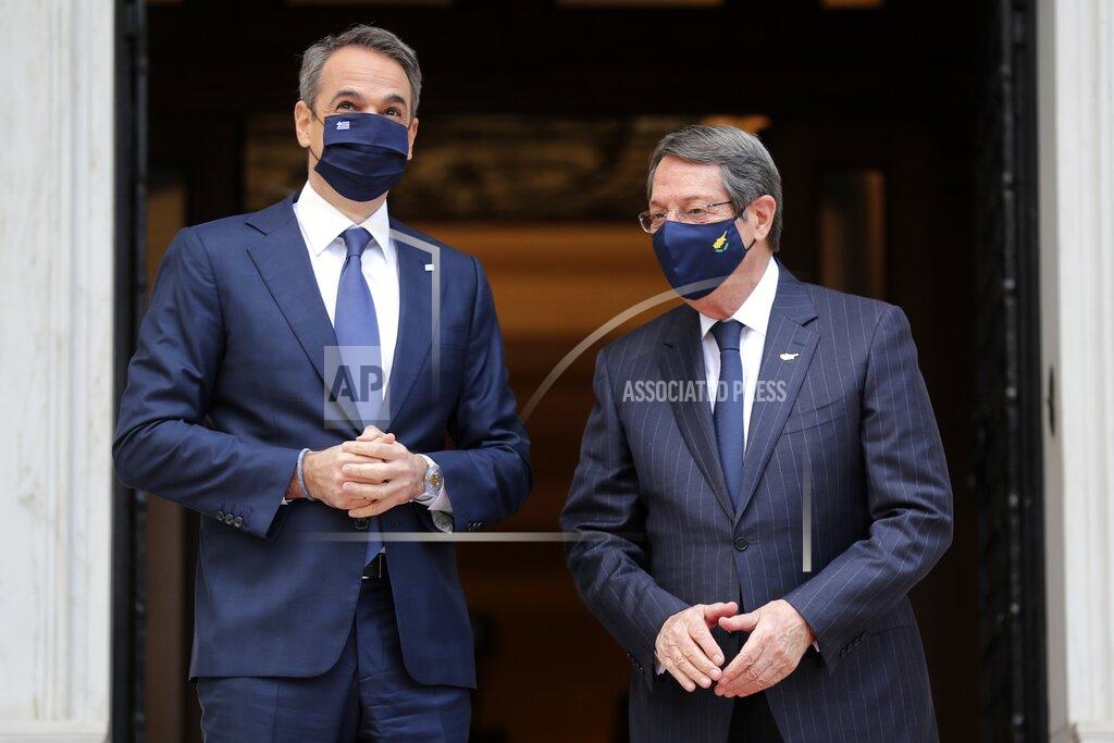 Petros Giannakouris Greece's Prime Minister Kyriakos Mitsotakis, left, welcomes Cypriot President Nicos Anastasiades at Maximos Mansion in Athens, Wednesday, March 24, 2021. The military parade on March 25, marking 200-years since the war that resulted in Greece's independence from the Ottoman Empire and rebirth as a nation, will be held without spectators due to the coronavirus, and only Greek and foreigners political officials. (AP Photo/Petros Giannakouris)
