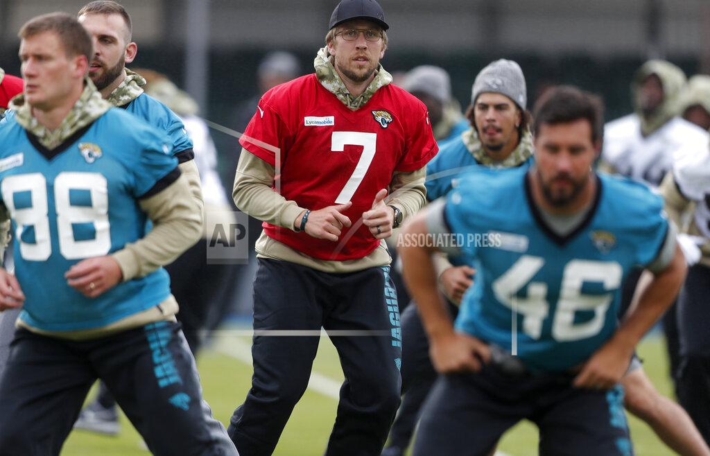 Frank Augstein Jaguars QB Nick Foles, centre, warms up with the team during a NFL training session of the Jacksonville Jaguars at the at Allianz Park in London, Friday, Nov. 1, 2019.The Jacksonville Jaguars are preparing for an NFL regular season game against the Houston Texans in London on Sunday. (AP Photo/Frank Augstein)