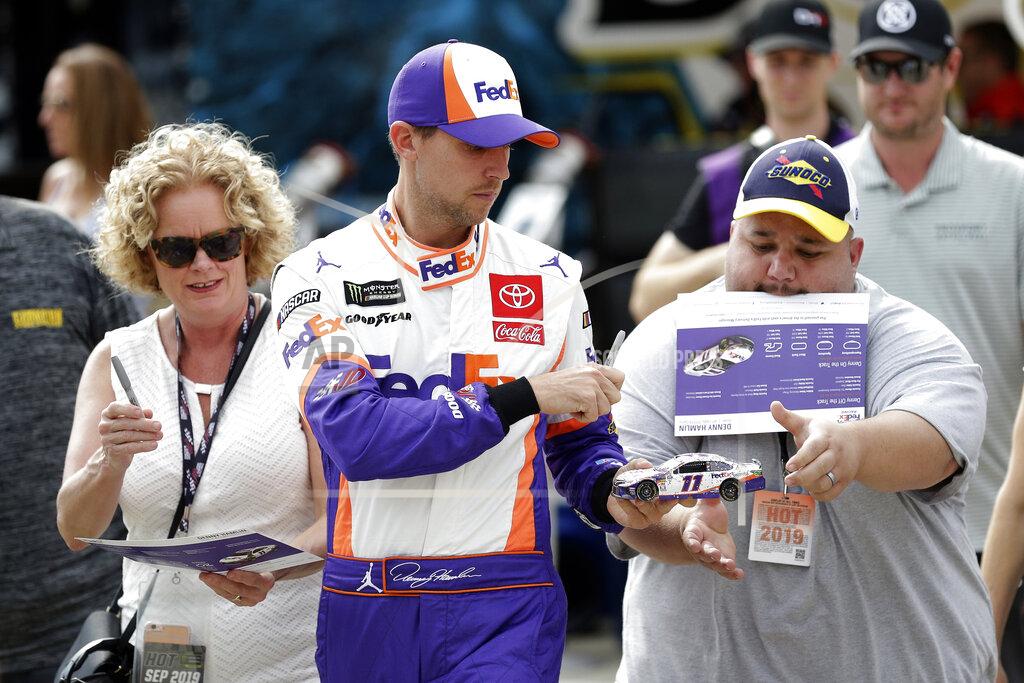 Gerry Broome Denny Hamlin signs autographs during practice for Sunday's NASCAR Cup Series auto race at Charlotte Motor Speedway in Concord, N.C., Saturday, Sept. 28, 2019. (AP Photo/Gerry Broome)