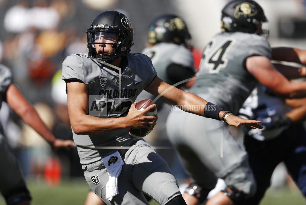 David Zalubowski Colorado quarterback Steven Montez scrambles away from New Hampshire defenders in the first half of an NCAA college football game Saturday, Sept. 15, 2018, in Boulder, Colo. (AP Photo/David Zalubowski)