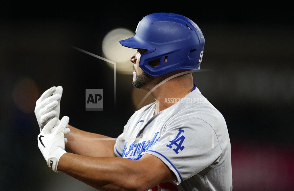 David Zalubowski Los Angeles Dodgers pinch-hitter Albert Pujols gestures to the dugout after hitting an RBI-single off Colorado Rockies relief pitcher Jhoulys Chacin in the 10th inning of a baseball game Tuesday, Sept. 21, 2021, in Denver. The Dodgers won 5-4. (AP Photo/David Zalubowski)