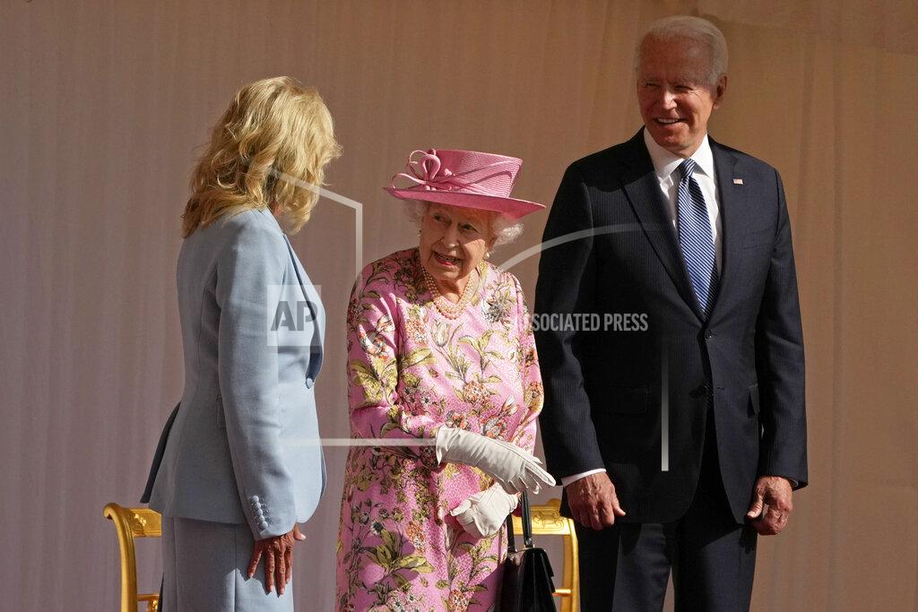 Matt Dunham Britain's Queen Elizabeth II speaks to US First Lady Jill Biden, left, while US President Joe Bidenlooks on, while watching a Guard of Honour march past before their meeting at Windsor Castle near London, Sunday, June 13, 2021. (AP Photo/Matt Dunham, Pool)