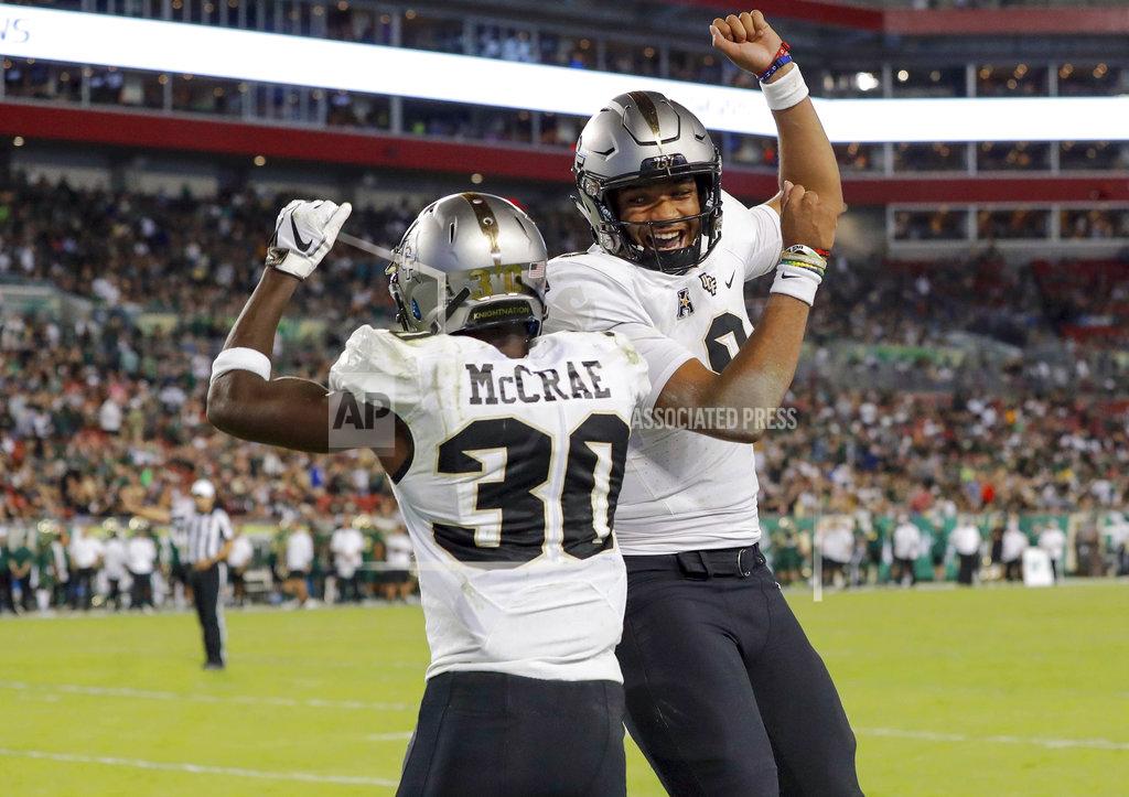 Mike Carlson Central Florida's Greg McCrae (30) celebrates with quarterback Darriel Mack Jr. after his third rushing touchdown against South Florida during the second half of an NCAA college football game Friday, Nov. 23, 2018, in Tampa, Fla. (AP Photo/Mike Carlson)