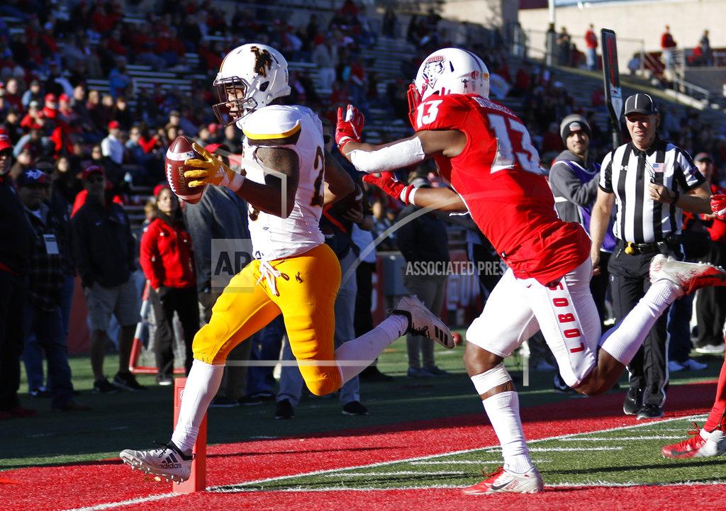 Andres Leighton Wyoming wide receiver Austin Conway, left, scores a touchdown ahead of New Mexico cornerback Jalin Burrell (13) during the second half of an NCAA college football game in Albuquerque, N.M., Saturday, Nov. 24, 2018. Wyoming won 31-3. (AP Photo/Andres Leighton)