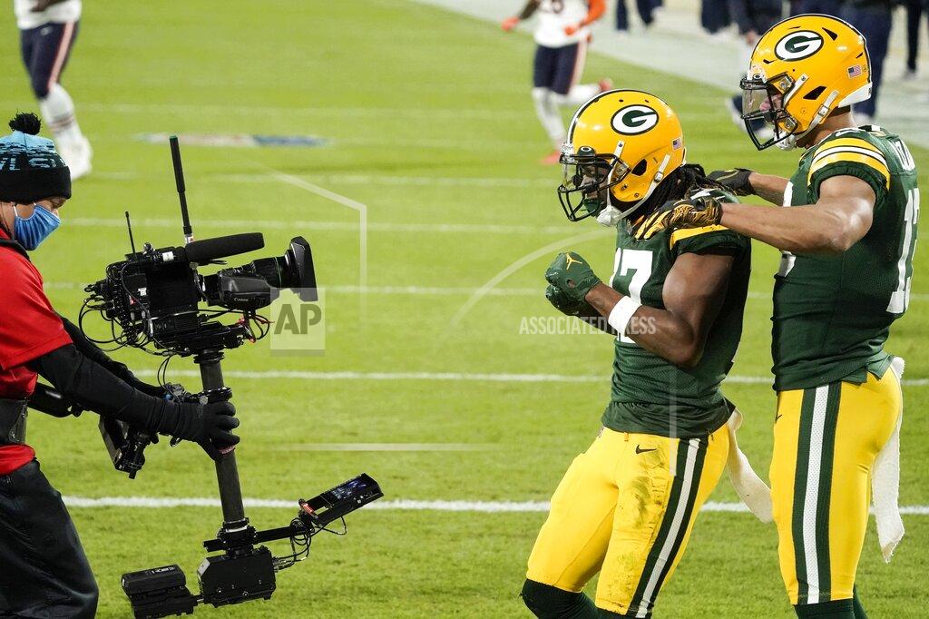 Morry Gash Green Bay Packers' Davante Adams reacts with teammate Allen Lazard after catching a touchdown pass during the first half of an NFL football game against the Chicago Bears Sunday, Nov. 29, 2020, in Green Bay, Wis. (AP Photo/Morry Gash)