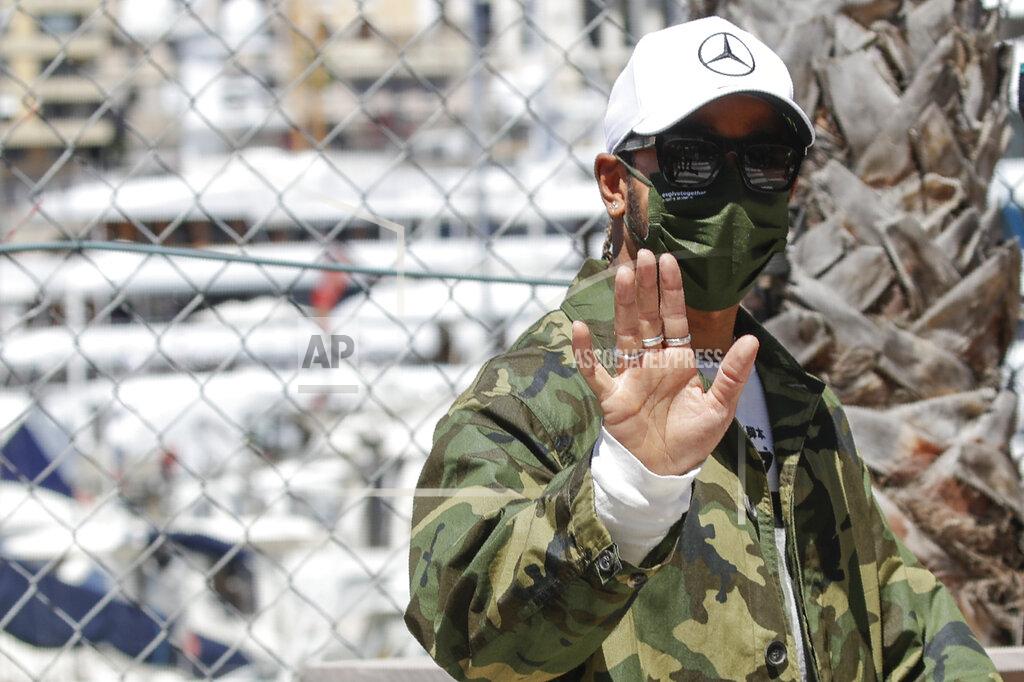 Luca Bruno Mercedes driver Lewis Hamilton of Britain waves to supporters as he walks in the paddock at the Monaco racetrack, in Monaco, Wednesday, May 19, 2021. The Formula one race will be held on Sunday. (AP Photo/Luca Bruno)