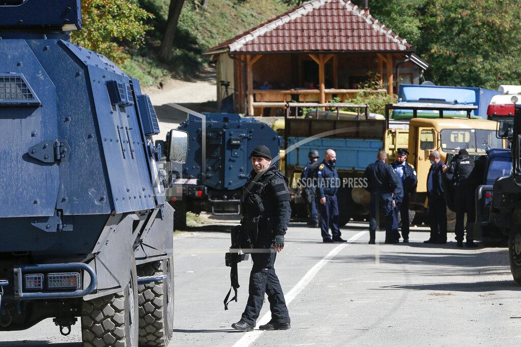 Visar Kryeziu Kosovo police officers secure the area at the barricades placed by local Serbs near the northern Kosovo border crossing of Brnjak on the fifth day of protest on Friday, Sept. 24, 2021. Ethnic Serbs in Kosovo have been blocking the border for a fifth straight day to protest a decision by Kosovo authorities to start removing Serbian license plates from cars entering the country, raising fears such incidents could unleash much deeper tensions between the two Balkan foes.(AP Photo/Visar Kryeziu)