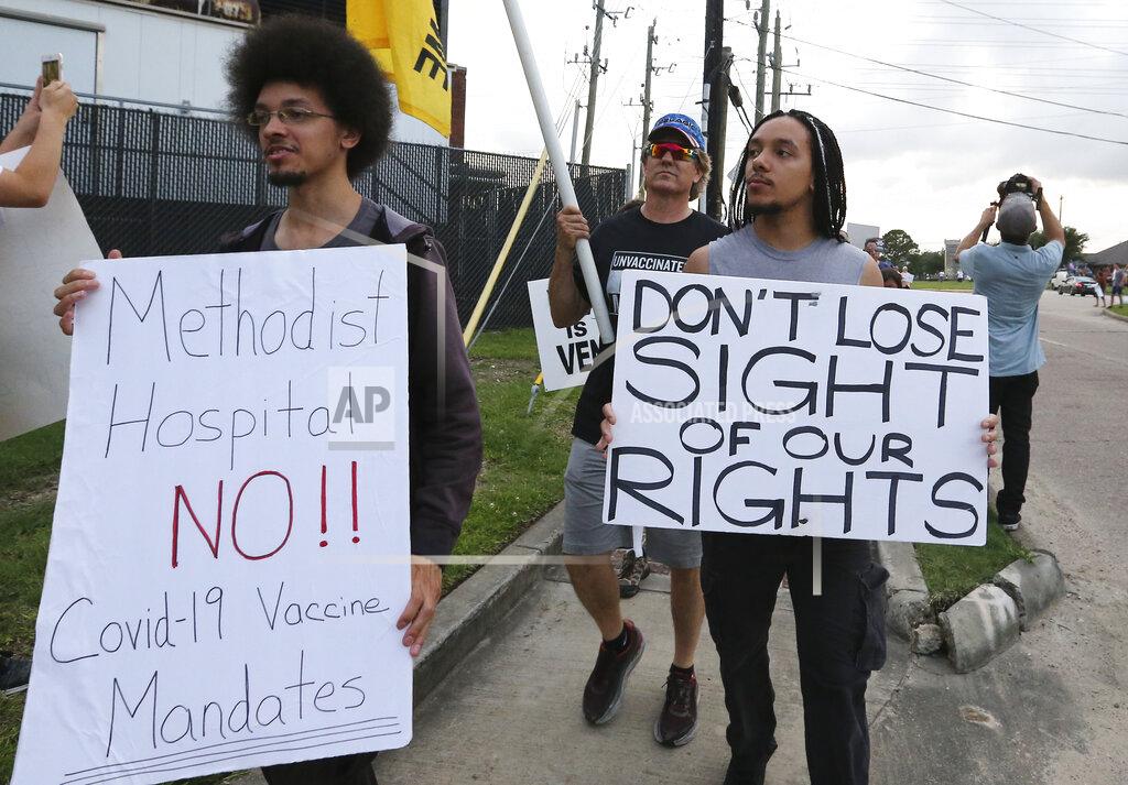 Yi-Chin Lee FILE - In this June 7, 2021, file photo, people march past Houston Methodist Baytown Hospital in Baytown, Texas, to protest against a policy that says hospital employees must get vaccinated against COVID-19 or lose their jobs. A federal judge dismissed their lawsuit, saying if workers don’t like the rule, they can go find another job. (Yi-Chin Lee/Houston Chronicle via AP, FIle)