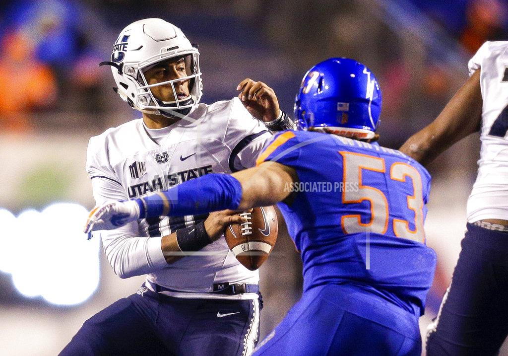 Steve Conner Utah State quarterback Jordan Love (10) tries to avoid the pressure brought by Boise State linebacker Sam Whitney (53) in the second of an NCAA college football game, Saturday, Nov. 24, 2018, in Boise, Idaho. Boise State won 33-24. (AP Photo/Steve Conner)