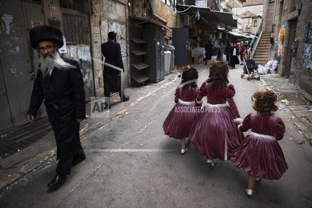 Oded Balilty Ultra-Orthodox Jewish girls wear costumes to celebrate the Jewish holiday of Purim in Jerusalem, Sunday, Feb. 28, 2021. The Jewish holiday of Purim commemorates the Jews' salvation from genocide in ancient Persia, as recounted in the biblical Book of Esther. (AP Photo/Oded Balilty)