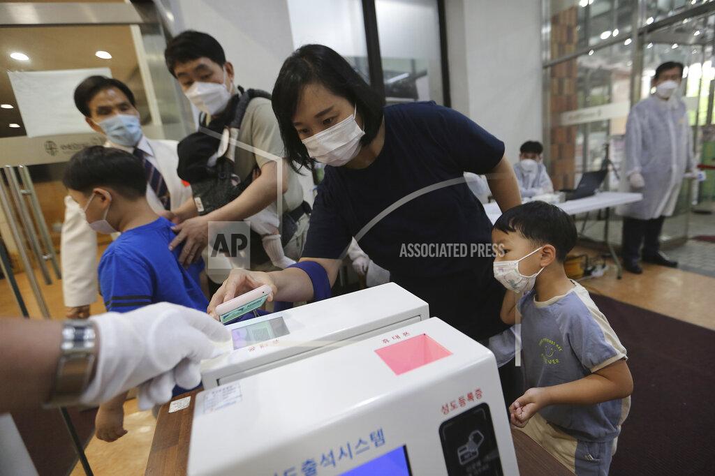 Ahn Young-Joon A Christian woman wearing a face mask to help protect against the spread of the new coronavirus scans a QR code on her smartphone before attending a service at the Yoido Full Gospel Church in Seoul, South Korea, Sunday, July 5, 2020. (AP Photo/Ahn Young-joon)