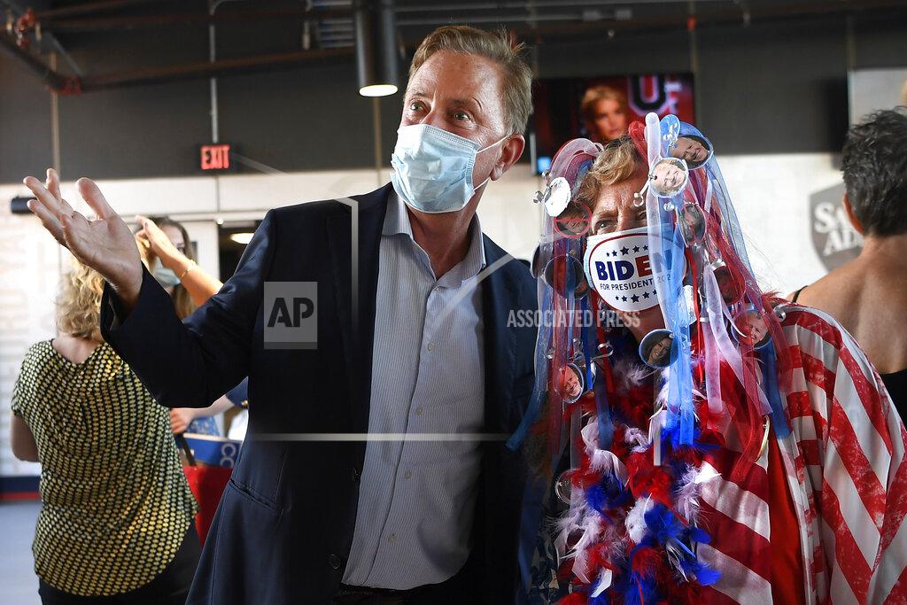 Jessica Hill Connecticut Gov. Ned Lamont talks to Audrey Blondin, right, of Torrington, during a watch party for the Democratic National Convention at Dunkin' Donuts Park, home of the Hartford Yard Goats minor league baseball team, Thursday, Aug. 20, 2020, in Hartford, Conn. (AP Photo/Jessica Hill)