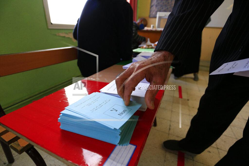 Toukik Doudou A man prepares to vote at a polling station during a vote for a revised constitution, in Algiers, Sunday, Nov. 1, 2020. Algerians are voting on whether to approve a revised constitution that imposes term limits and aims at answering demands from pro-democracy protesters who pushed out the president last year. (AP Photo/Toufik Doudou)