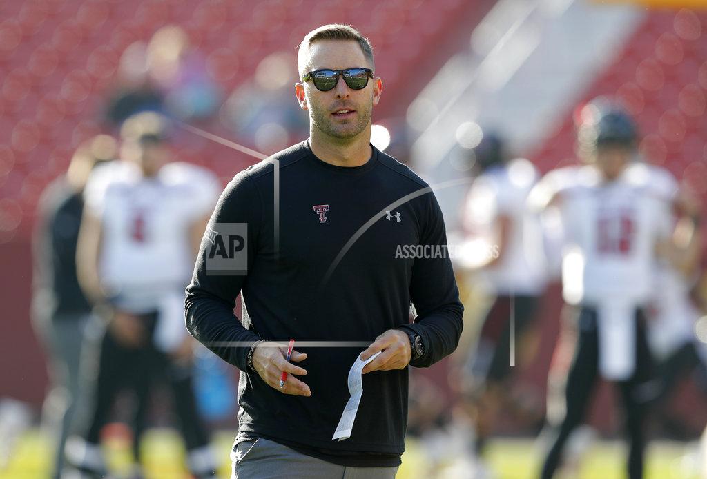 Charlie Neibergall File-This Oct. 27, 2018, file photo shows Texas Tech head coach Kliff Kingsbury standing on the field before an NCAA college football game against Iowa State, in Ames, Iowa. A win in their regular season finale at Texas last season likely saved Kingsbury’s job. It is unclear what impact, if any, the outcome of this game might have on Kingsbury’s future. “Dealt with a lot of that last year, and this year the focus has just been on our team and our program and these seniors, and so that's what my focus is this week is, hey, how can we extend this season for these seniors,” Kingsbury said. (AP Photo/Charlie Neibergall, File)