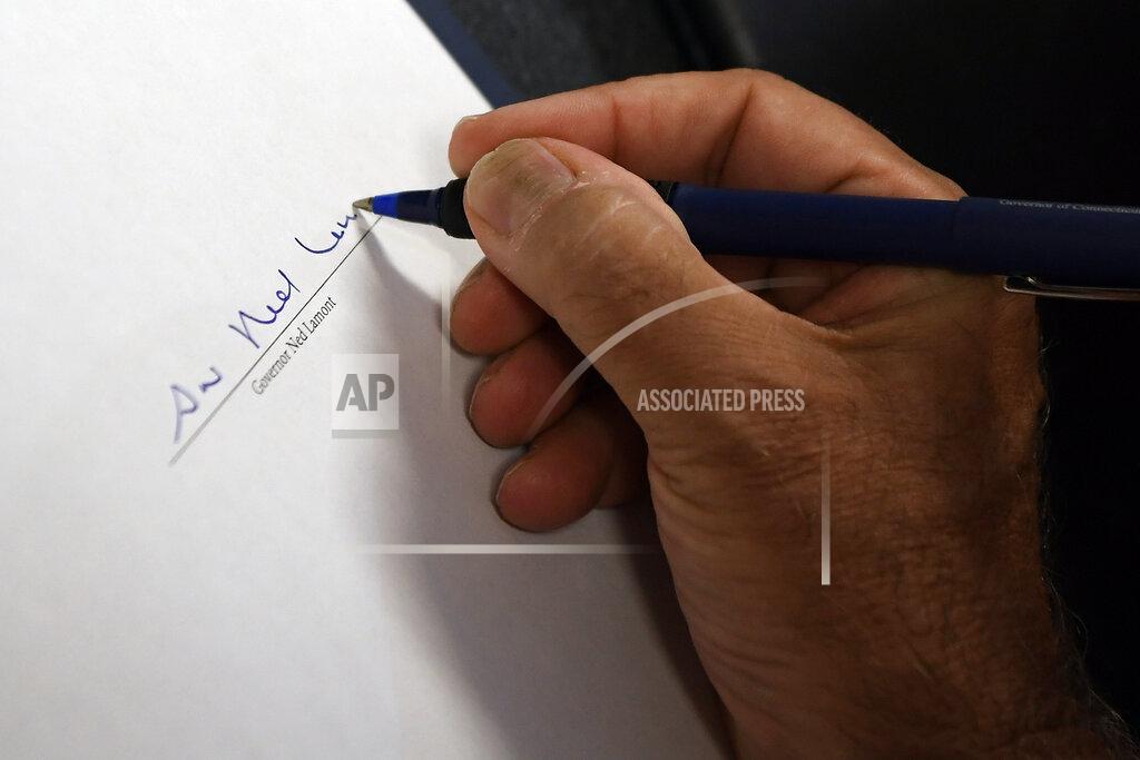 Jessica Hill Connecticut Gov. Ned Lamont signs a ceremonial bill on gun safety at Hartford Communities That Care, Tuesday, July 27, 2021 in Hartford, Conn. (AP Photo/Jessica Hill)