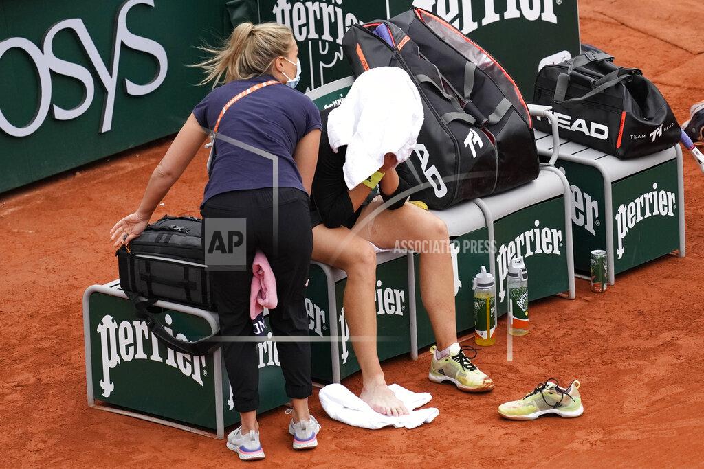 Christophe Ena Karolina Muchova of the Czech Republic gets medical assistance after falling as she plays Amanda Anisimova of the U.S.during their third round match of the French Open tennis tournament at the Roland Garros stadium Friday, May 27, 2022 in Paris. (AP Photo/Christophe Ena)