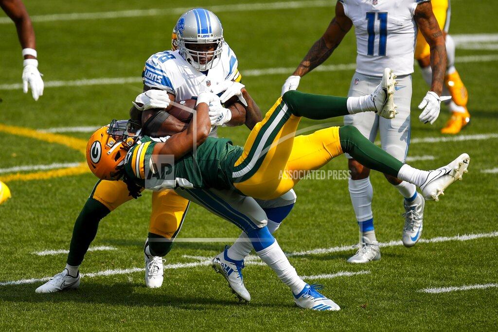 Matt Ludtke Green Bay Packers' Kevin King and Chandon Sullivan stop Detroit Lions' Adrian Peterson during the first half of an NFL football game Sunday, Sept. 20, 2020, in Green Bay, Wis. (AP Photo/Matt Ludtke)