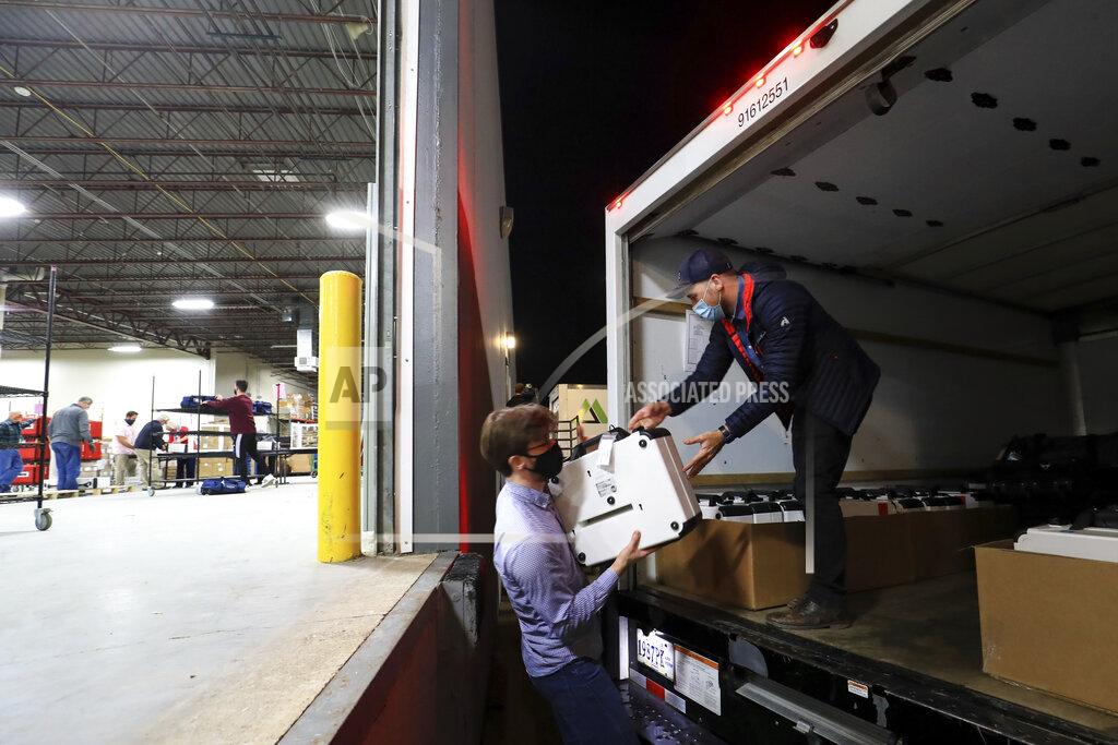 Aaron Doster Hamilton County election department employees unload ballot boxes from delivery trucks at the Hamilton County Board of Elections, Tuesday, Nov. 3, 2020, in Norwood, Ohio. (AP Photo/Aaron Doster)