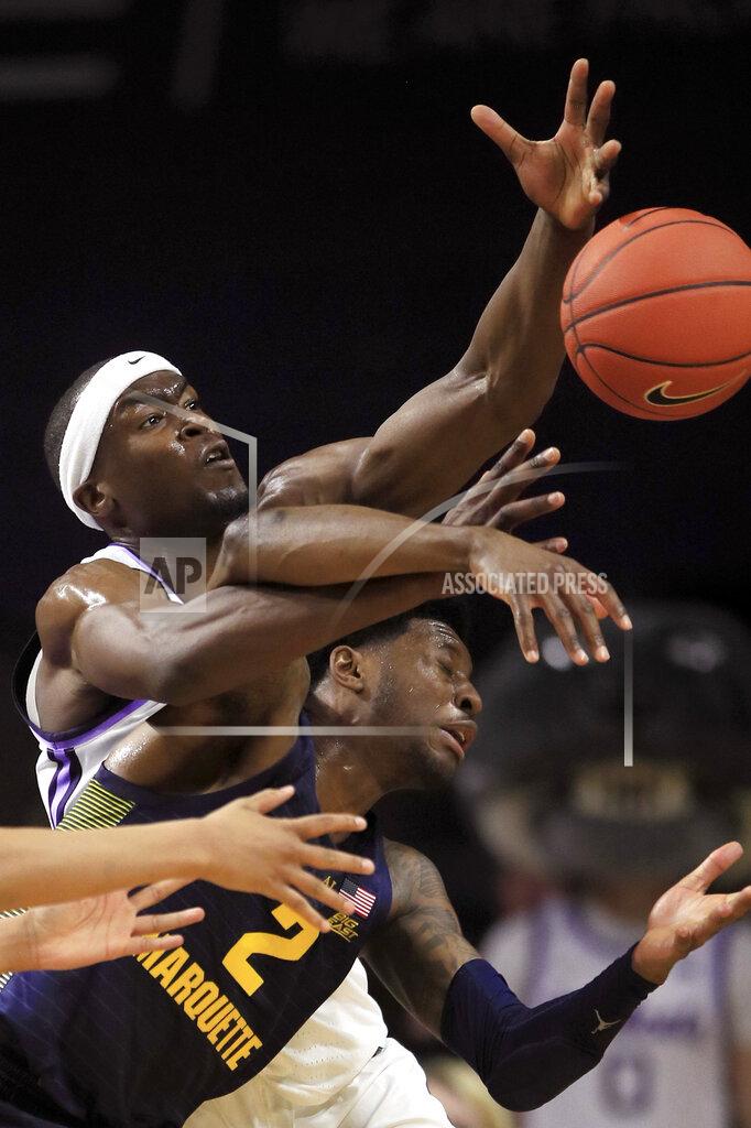 Orlin Wagner Kansas State forward Makol Mawien, left, tries to rebound over Marquette guard Sacar Anim (2) during the first half of an NCAA college basketball game in Manhattan, Kan., Saturday, Dec. 7, 2019. (AP Photo/Orlin Wagner)