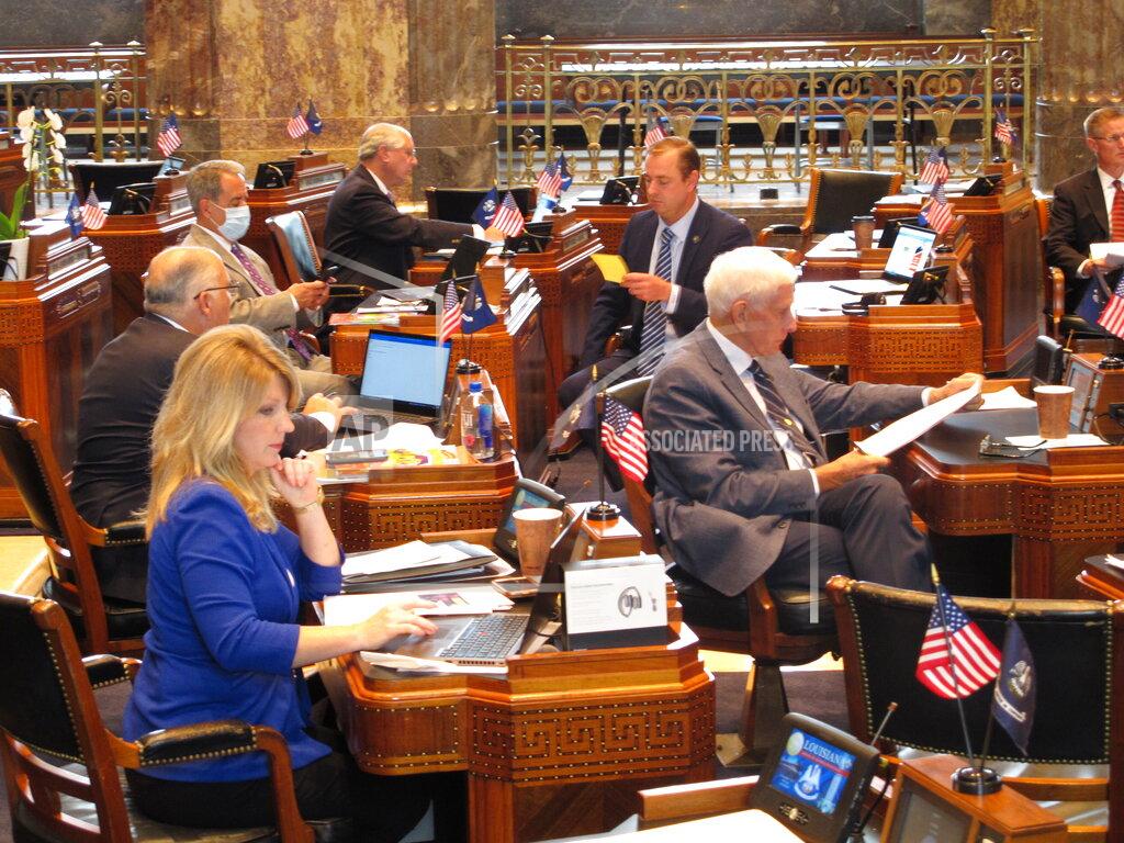Louisiana state senators read through messages and bills on the Senate floor as the Legislature wraps up its regular session on Monday, June 1, 2020, in Baton Rouge, La. (AP Photo/Melinda Deslatte)