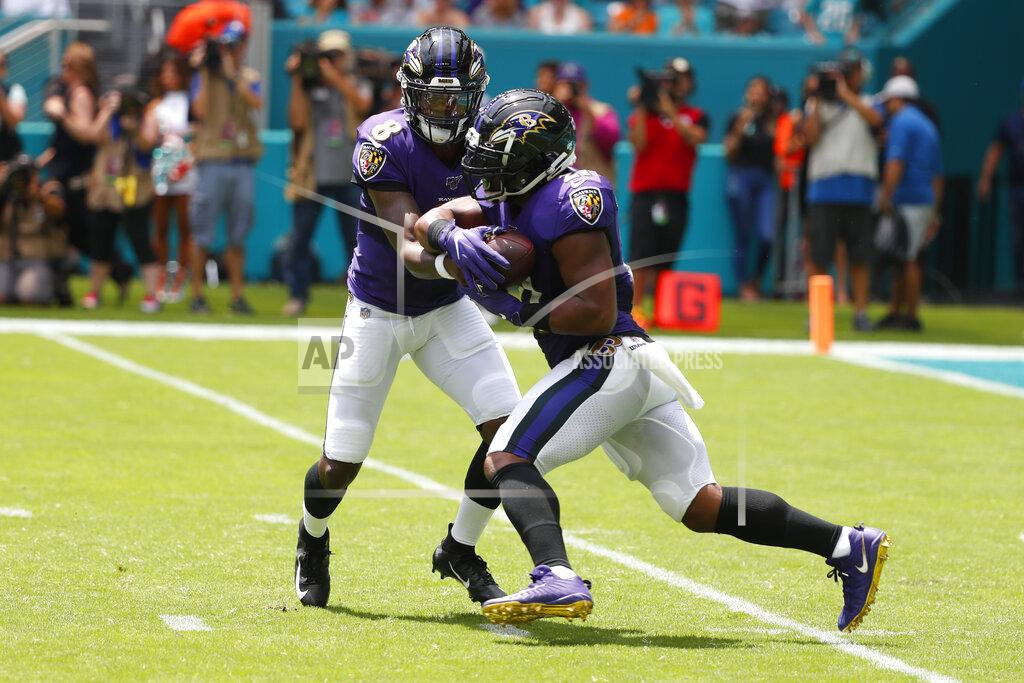 Wilfredo Lee Baltimore Ravens quarterback Lamar Jackson (8) hands the ball to running back Mark Ingram (21), during the first half at an NFL football game against the Miami Dolphins, Sunday, Sept. 8, 2019, in Miami Gardens, Fla. (AP Photo/Wilfredo Lee)