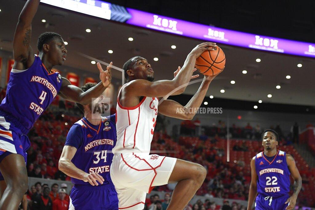 Justin Rex Houston forward Fabian White Jr. shoots in front of Northwestern State center Kendal Coleman (4) and forward Robert Chougkaz (34) during the first half of an NCAA college basketball game Tuesday, Nov. 30, 2021, in Houston. (AP Photo/Justin Rex)