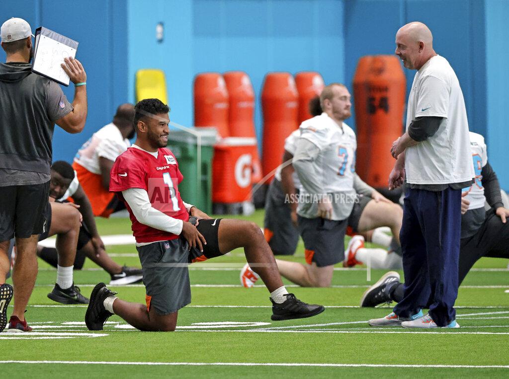 David Santiago Miami Dolphins co-offensive coordinator George Godsey talks with Dolphins quarterback Tua Tagovailoa (1) during NFL football practice in Miami Gardens, Fla., Wednesday, Oct. 20, 2021. The Atlanta Falcons play at Miami on Sunday. (David Santiago/Miami Herald via AP)