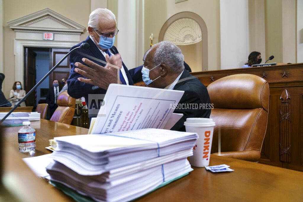 J. Scott Applewhite Rep. Bill Pascrell, D-N.J., left, and Rep. Danny Davis, D-Ill., confer as the tax-writing House Ways and Means Committee continues working on a sweeping proposal for tax hikes on big corporations and the wealthy to fund President Joe Biden's $3.5 trillion domestic rebuilding plan, at the Capitol in Washington, Tuesday, Sept. 14, 2021. (AP Photo/J. Scott Applewhite)