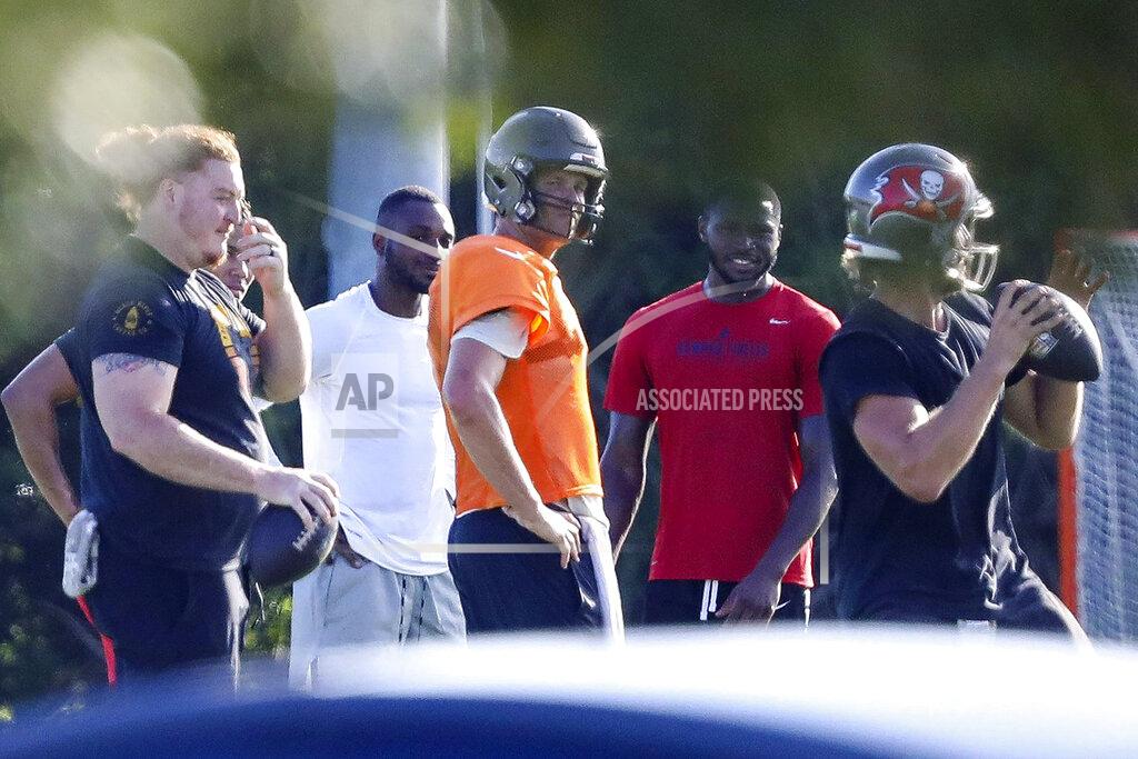 Chris Urso Tampa Bay Buccaneers center Ryan Jensen, far left, along with safety Mike Edwards, second from left, quarterback Tom Brady, center in orange, cornerback Jamel Dean, second from right, and quarterback Blaine Gabbert are seen during a private workout Tuesday, June 23, 2020, at Berkeley Preparatory School in Tampa, Fla. (Chris Urso/Tampa Bay Times via AP)