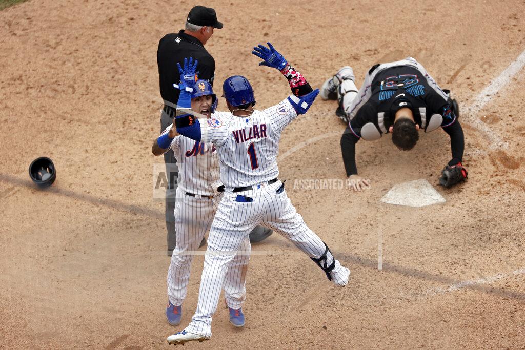 Adam Hunger New York Mets' Javier Baez celebrates with Jonathan Villar after scoring the game winning run past Miami Marlins catcher Alex Jackson during the ninth inning of the first game of a baseball doubleheader that started April 11 and was suspended because of rain, Tuesday, Aug. 31, 2021, in New York. The Mets won 6-5. (AP Photo/Adam Hunger)