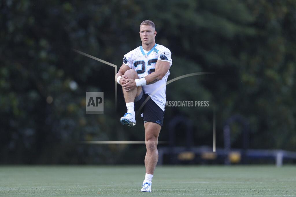 Carolina Panthers running back Christian McCaffrey stretches at the NFL football team's training camp in Spartanburg, S.C., Wednesday, July 28, 2021. (AP Photo/Nell Redmond)