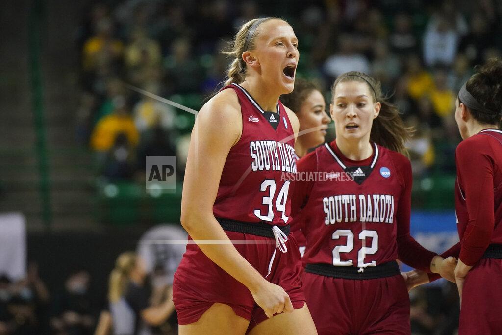 Lm Otero South Dakota center Hannah Sjerven (34) screams as she heads to huddle with guard Chloe Lamb (22) and other teammates during the first half of a college basketball game against Baylor in the second round of the NCAA tournament in Waco, Texas, Sunday, March 20, 2022. (AP Photo/LM Otero)