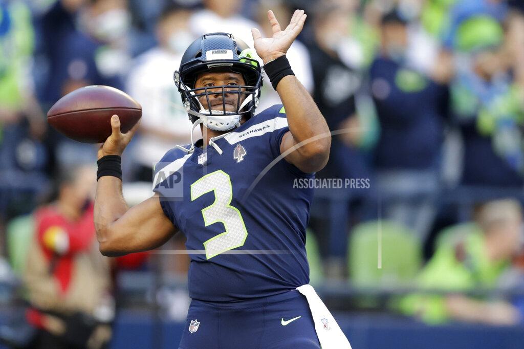 John Froschauer Seattle Seahawks quarterback Russell Wilson warms up for the team's NFL football preseason game against the Los Angeles Chargers, Saturday, Aug. 28, 2021, in Seattle. (AP Photo/John Froschauer)
