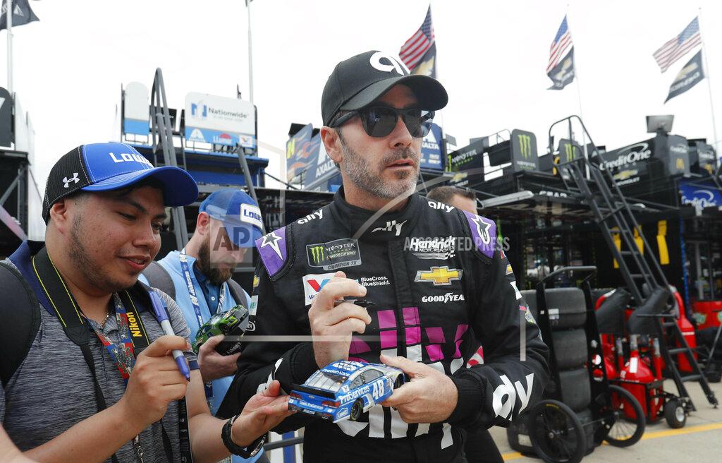 Lm Otero Jimmie Johnson looks up while signing autographs before practice for the NASCAR Cup Series auto race at Texas Motor Speedway in Fort Worth, Texas, Friday, March 29, 2019. (AP Photo/LM Otero)