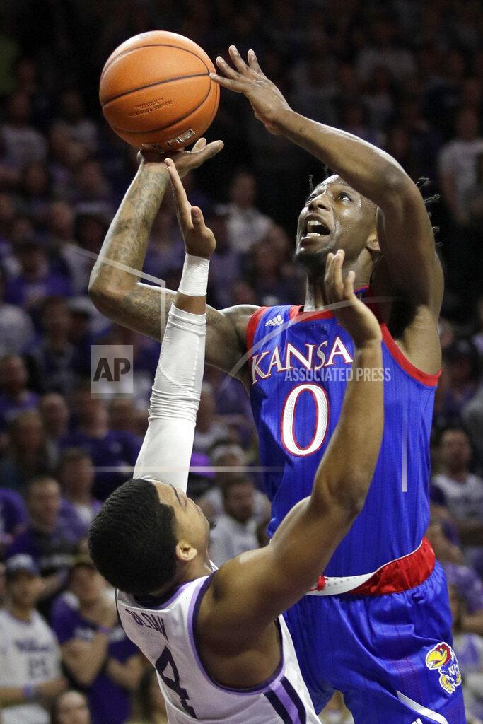 Orlin Wagner FILE - Kansas guard Marcus Garrett (0) shoots over Kansas State guard David Sloan (4) during the first half of an NCAA college basketball game in Manhattan, Kan., in this Saturday, Feb. 29, 2020, file photo. The Jayhawks will be challenged enough in the Big 12, where a double round-robin means two games each against second-ranked Baylor, No. 14 Texas Tech, No. 15 West Virginia and No. 19 Texas. (AP Photo/Orlin Wagner, File)