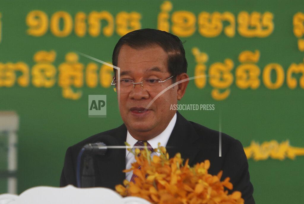 Heng Sinith Cambodian Prime Minister Hun Sen smiles as his delivers a speech during a handover ceremony at Phnom Penh International Airport, in Phnom Penh, Cambodia, Sunday, Feb. 7, 2021. Cambodia on Sunday received its first shipment of COVID-19 vaccine, a donation of 600,000 doses from China, the country's biggest ally. Beijing has been making such donations to several Southeast Asian and African nations in what has been dubbed "vaccine diplomacy," aimed especially at poorer countries like Cambodia. (AP Photo/Heng Sinith)
