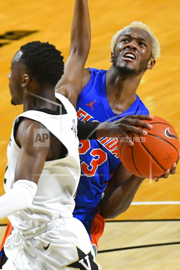 John Amis Florida guard Scottie Lewis (23) looks to the basket as Vanderbilt guard Trey Thomas defends during the second half of an NCAA college basketball game Wednesday, Dec. 30, 2020, in Nashville, Tenn. (AP Photo/John Amis)