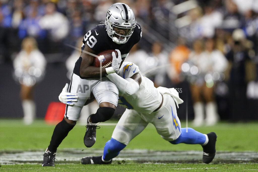 Ellen Schmidt Los Angeles Chargers middle linebacker Kenneth Murray (9) tackles Las Vegas Raiders wide receiver Bryan Edwards (89) after a catch during the first half of an NFL football game, Sunday, Jan. 9, 2022, in Las Vegas. (AP Photo/Ellen Schmidt)