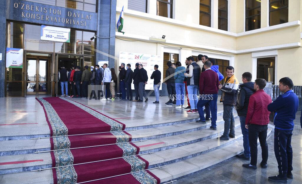 Uncredited People stand in a line at a polling station during the presidential election in Tashkent, Uzbekistan, Sunday, Oct. 24, 2021. Uzbeks voted Sunday in a presidential election that the incumbent is expected to win in a landslide against weak competition. Although Shavkat Mirziyoyev has relaxed many of the policies of his dictatorial predecessor, he has made little effort at political reform. He took office in 2016 upon the death of Islam Karimov and faces four relatively low-visibility candidates who did not even show up for televised debates. (AP Photo)
