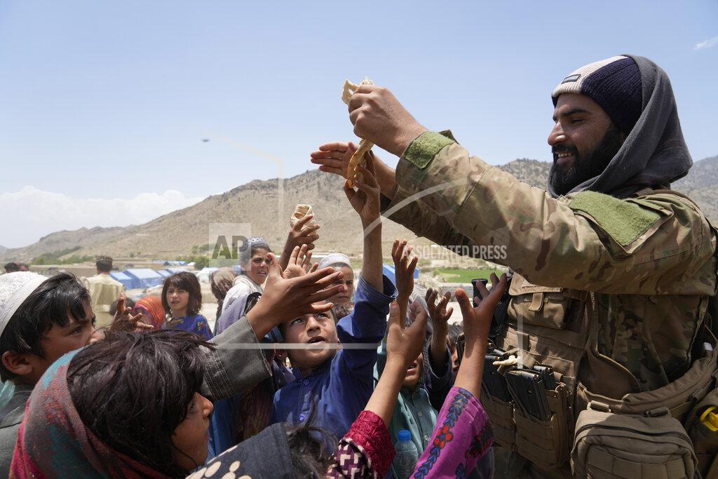 Ebrahim Noroozi Afghans receive aid at a camp after an earthquake in Gayan district in Paktika province, Afghanistan, Sunday, June 26, 2022. A powerful earthquake struck a rugged, mountainous region of eastern Afghanistan early Wednesday, flattening stone and mud-brick homes in the country's deadliest quake in two decades, the state-run news agency reported. (AP Photo/Ebrahim Nooroozi)