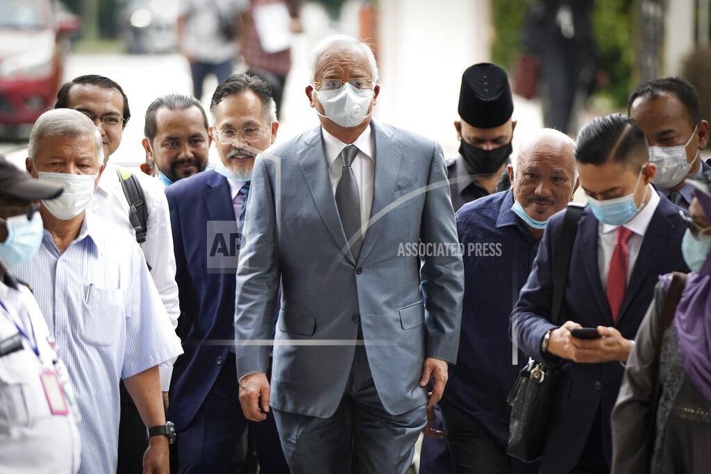 Vincent Thian Former Malaysian Prime Minister Najib Razak, center, wearing a face mask walks toward court house in Kuala Lumpur, Malaysia, Thursday, June 4, 2020. Closing arguments are expected in the first corruption trial of him linked to the multibillion-dollar looting of the 1MDB state investment fund. (AP Photo/Vincent Thian)