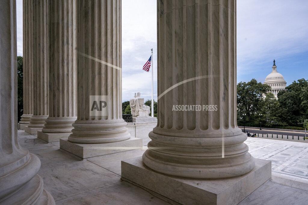 FILE - In this June 15, 2020, file photo the columns of the Supreme Court are seen with the Capitol at right, in Washington. The Senate is ready to move quickly on a Supreme Court nominee. President Donald Trump is expected Saturday, Sept. 26, to announce his replacement for the late Justice Ruth Bader Ginsburg. (AP Photo/J. Scott Applewhite, File)