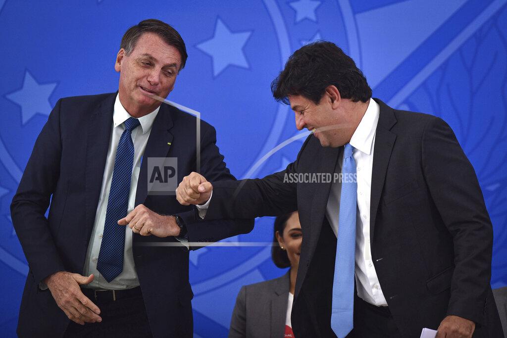 Andre Borges Brazil's President Jair Bolsonaro, left, greets his outgoing Health Minister Luiz Henrique Mandetta during the swearing-in ceremony for the new Health Minister Nelson Teich, not in picture, at Planalto palace in Brasilia, Brazil, Friday, April 17, 2020. Mandetta had garnered support for his handling of the pandemic that included promotion of broad isolation measures enacted by state governors, but had drawn the ire of Bolsonaro, who has said shutting down the economy would cause more damage than confining only high-risk Brazilians. (AP Photo/Andre Borges)