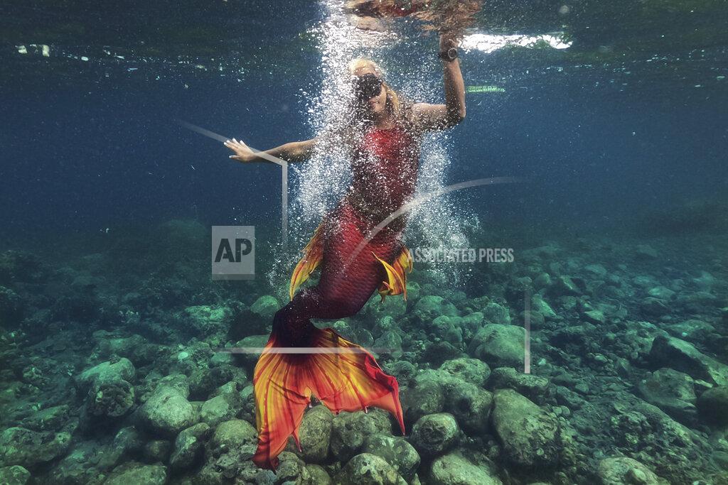 Aaron Favila Queen Pangke Tabora swims in her mermaid suit while she conducts a mermaiding class in front of the Ocean Camp in Mabini, Batangas province, Philippines on Sunday, May 22, 2022. “The world outside is really noisy and you will find peace under water. … It’s a good skill in the real world, especially during the pandemic.” (AP Photo/Aaron Favila)