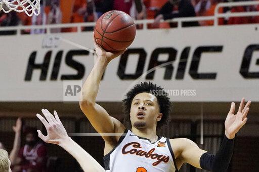 Sue Ogrocki FILE - Oklahoma State guard Cade Cunningham (2) shoots against Arkansas in the second half of an NCAA college basketball game in Stillwater, Okla., in this Saturday, Jan. 30, 2021, file photo. Cade Cunningham has announced he will enter the NBA draft after a dynamic freshman season that saw him named a first-team AP All-American. (AP Photo/Sue Ogrocki, File)
