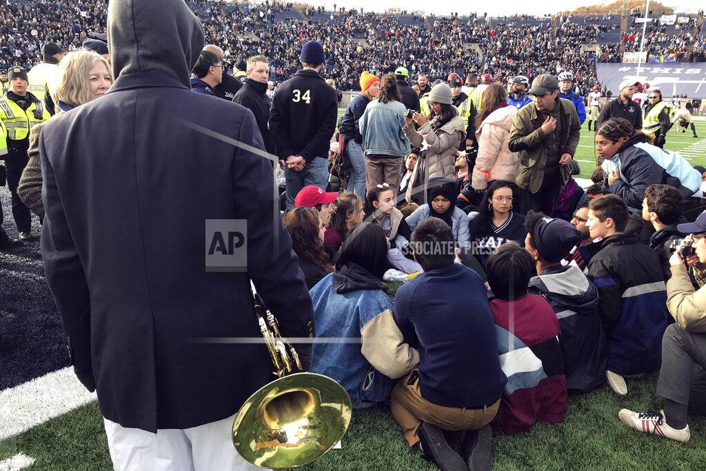 Jimmy Golen Demonstrators stage a protest on the field at the Yale Bowl disrupting the start of the second half of an NCAA college football game between Harvard and Yale, Saturday, Nov. 23, 2019, in in New Haven, Conn. (AP Photo/Jimmy Golen)