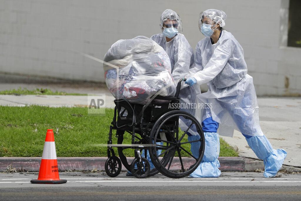 Chris Carlson Workers load the personal belongings of patient being evacuated from the Magnolia Rehabilitation and Nursing Center in Riverside, Calif., Wednesday, April 8, 2020. More than 80 patients from a Riverside skilled nursing facility are being evacuated this morning to other healthcare locations throughout Riverside County, Calif. (AP Photo/Chris Carlson)