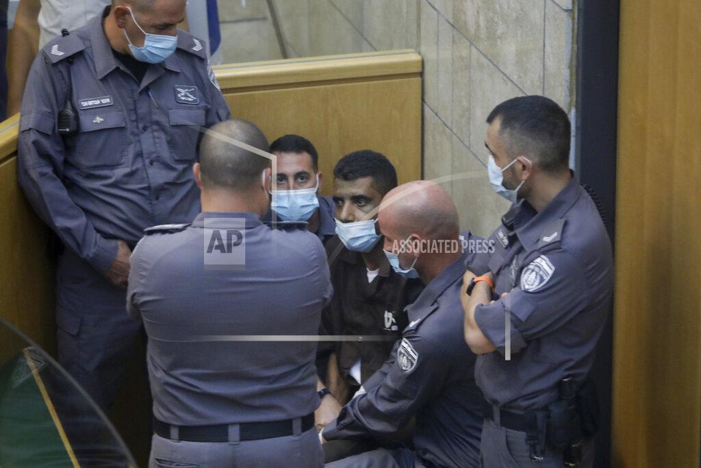 Sebastian Scheiner Zakaria Zubeidi, one of the six Palestinians who escaped from a high-security prison earlier this week is surrounded by guards as they stand in a courtroom in Nazareth, Israel, after he and three other Palestinian fugitives were captured on Saturday, Sept. 11, 2021. Israeli police on Saturday said they have arrested four of the six Palestinians who broke out of a maximum-security prison this week including Zubeidi a famed militant leader whose exploits over the years have made him a well-known figure in Israel. (AP Photo/Sebastian Scheiner)