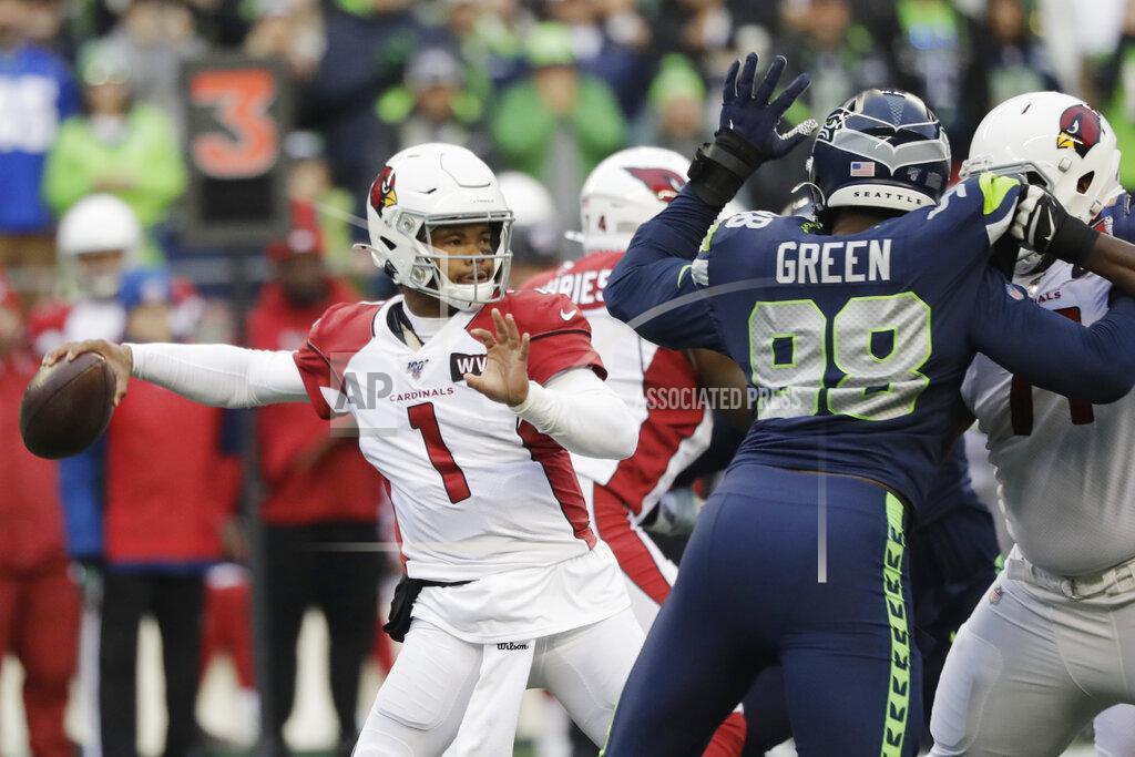 Elaine Thompson In this Sunday, Dec. 22, 2019, photo, Arizona Cardinals quarterback Kyler Murray passes as Seattle Seahawks defensive end Rasheem Green (98) applies pressure during the first half of an NFL football game in Seattle. Murray is short for an NFL quarterback at 5-foot-10, but it hasn't kept him from being very productive under first-year coach Kliff Kingsbury. Coaches and veteran players like receiver Larry Fitzgerald have raved about Murray's leadership, talent and toughness. (AP Photo/Elaine Thompson)